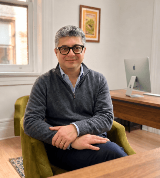 Dr. Omidvari seated in his office in the Flatiron District of Manhattan